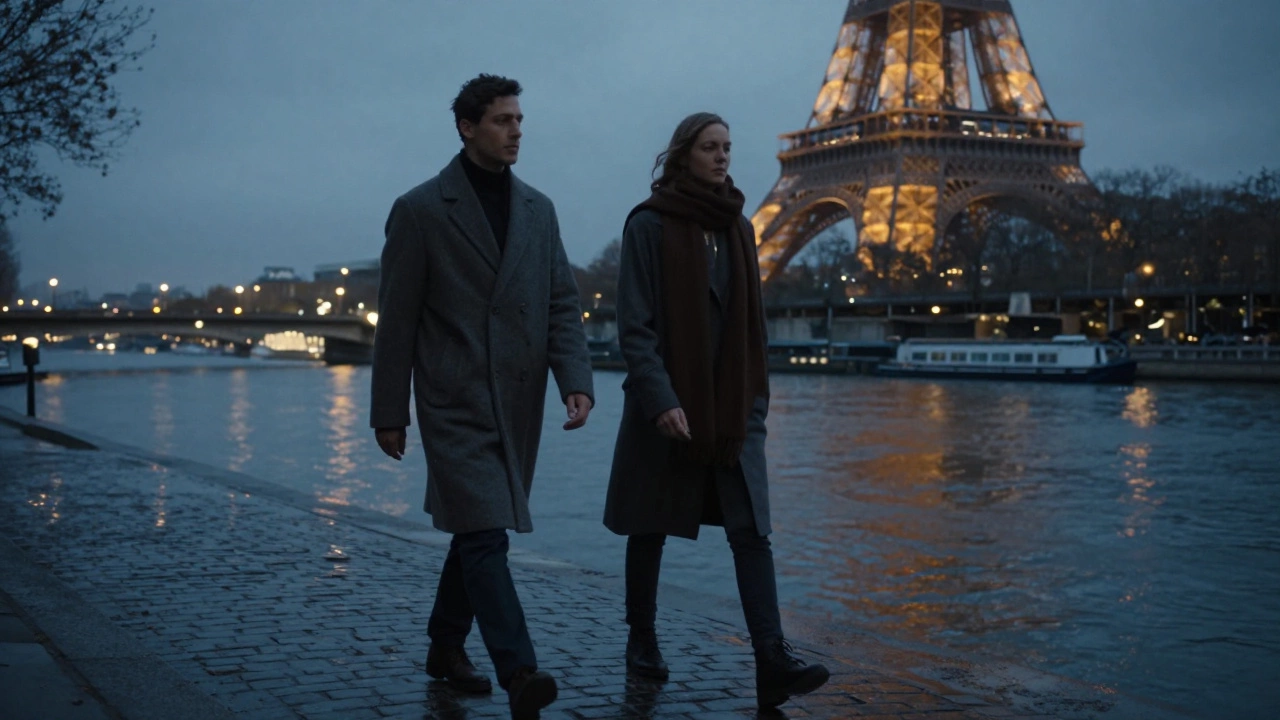 A man and woman walking peacefully along the Seine at dusk, the Eiffel Tower glowing softly in the background.